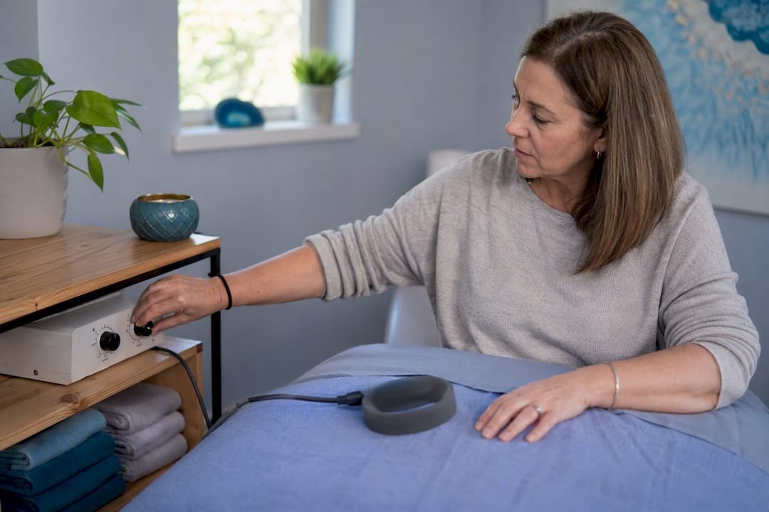 Woman adjusting PEMF device settings
