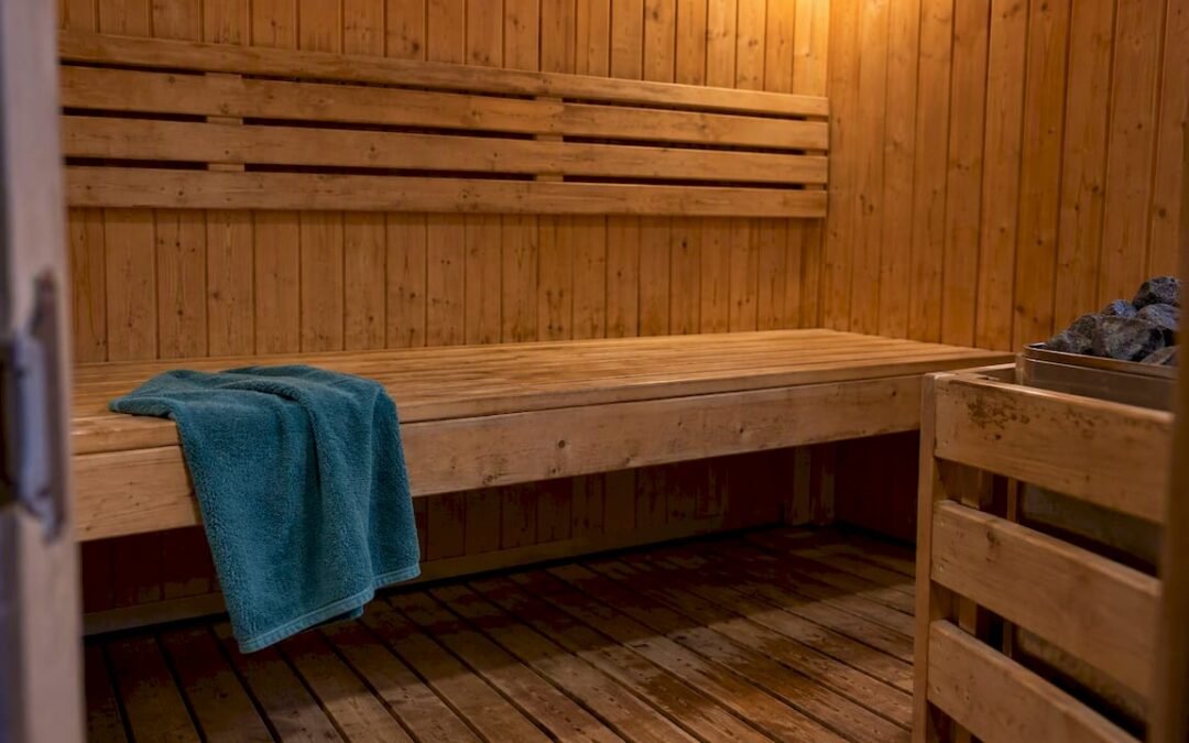 Wood-lined sauna with a teal towel
